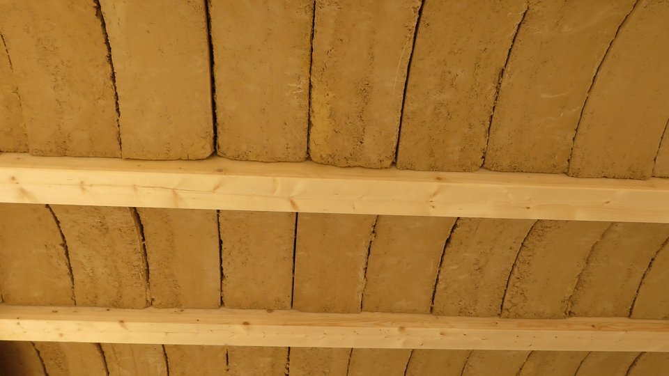 Raumdecke mit Holzträgern und dazwischen liegend gewölbte Lehmziegel